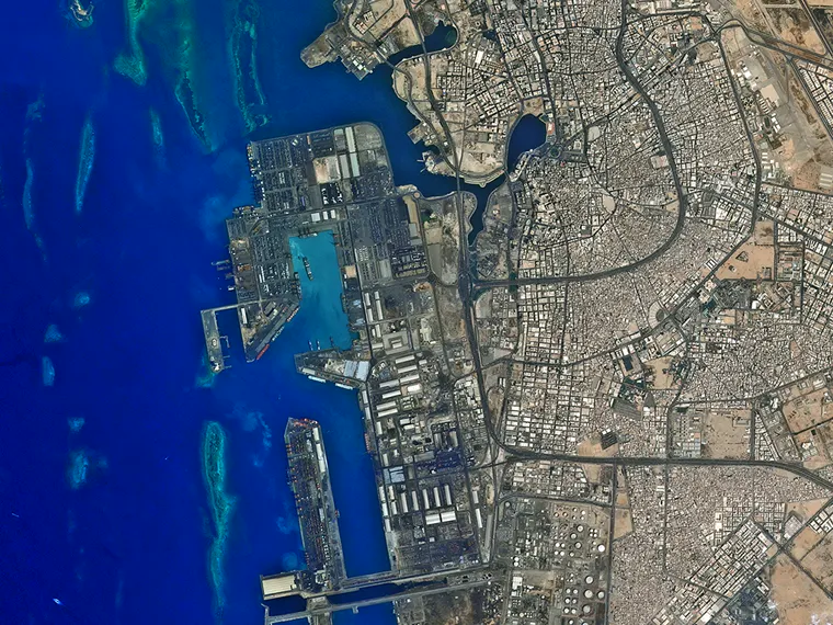 The seaport at Jeddah photographed from orbit, quays and container yards visible against the Red Sea shelf.