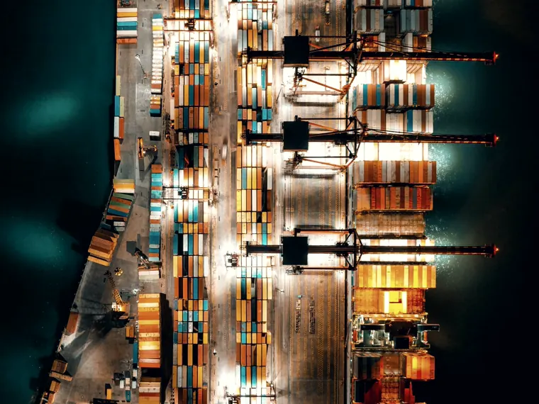 A container terminal working at night, seen from above.